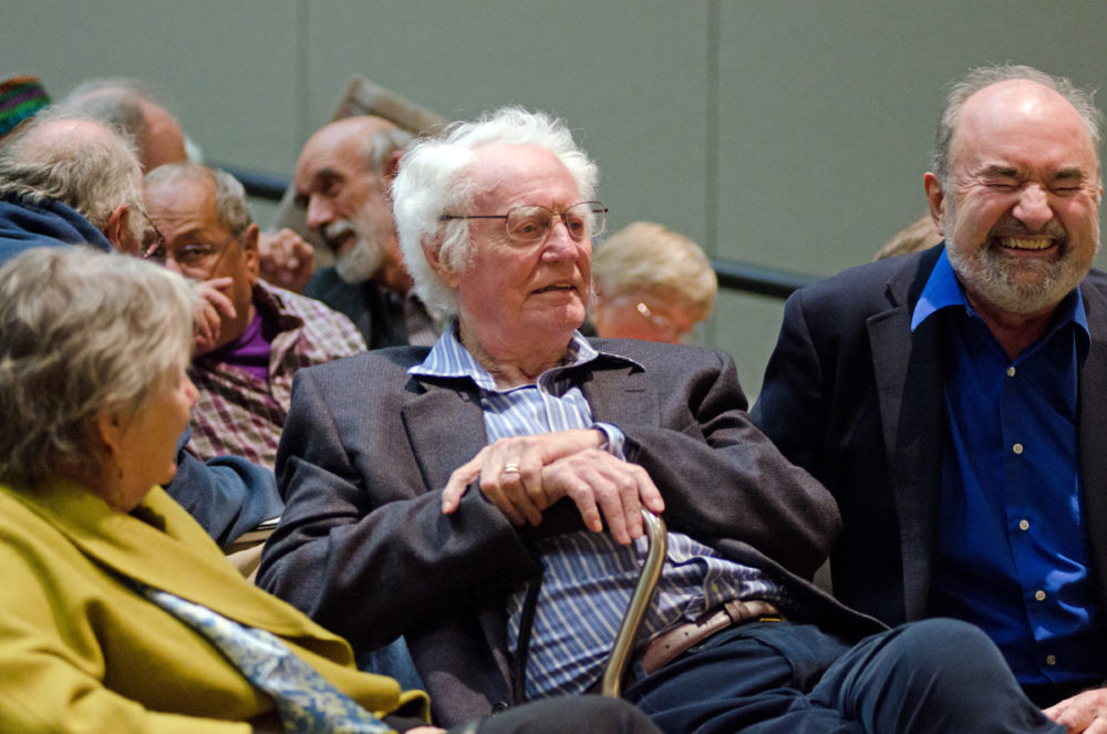 Robert Bly chats with fellow poet Michael Dennis Browne, who is laughing
