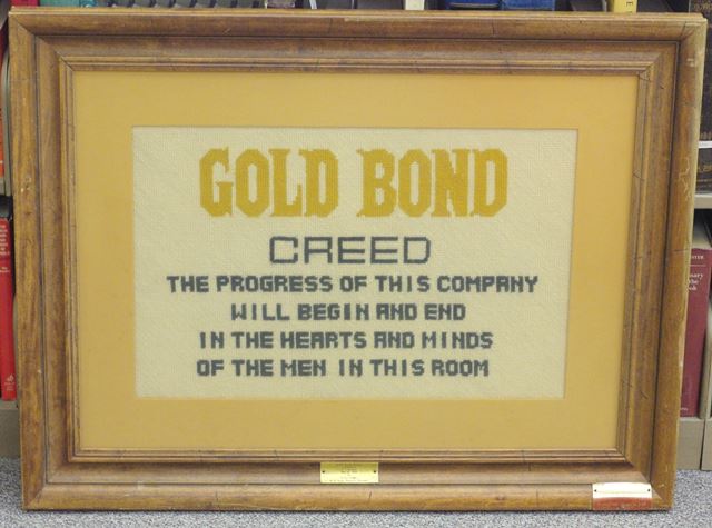 Crewel worked Gold Bond Stamp Company Creed produced by wife of early Gold Bond Stamp Company executive – “The Progress of this Company will begin and end in the hearts and minds of the men in this room.”