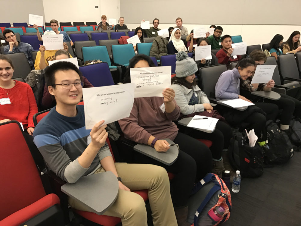 Students participate in a class learning how to think like a researcher