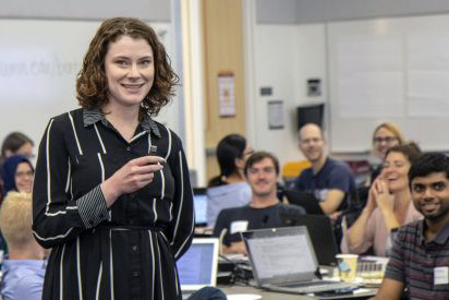 Caitlin Bakker teaching in front of a classroom
