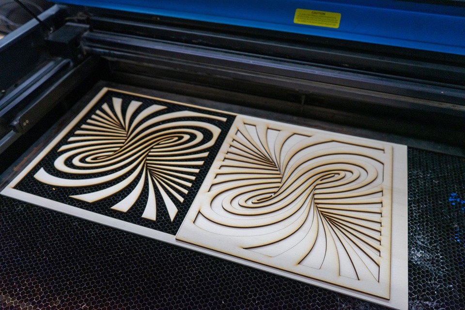 Photo of positive and negative cuts from a laser cutter.
