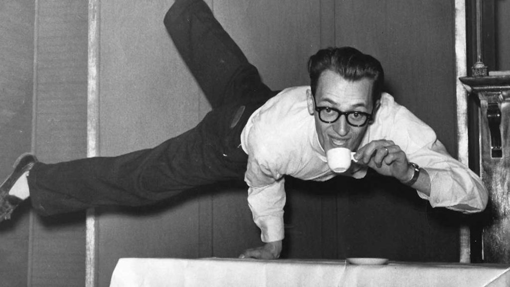 Dudley Riggs balancing on one hand