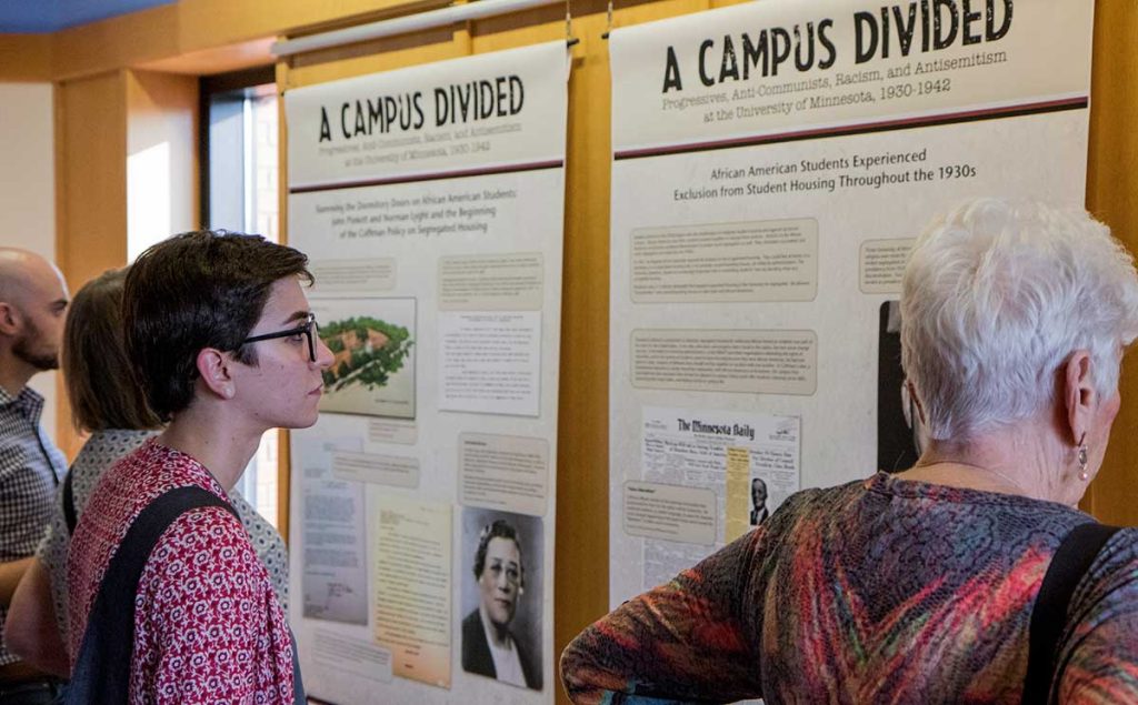 People viewing the Campus Divided exhibit