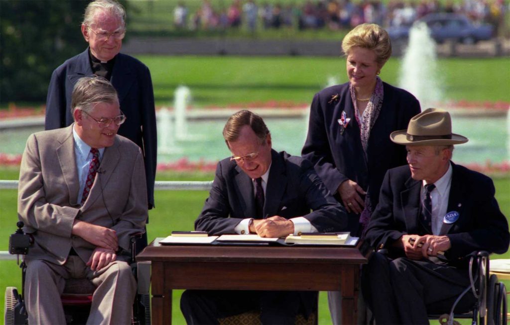 President George H. W. Bush Signs the Americans with Disabilities Act, July 26, 1990.
