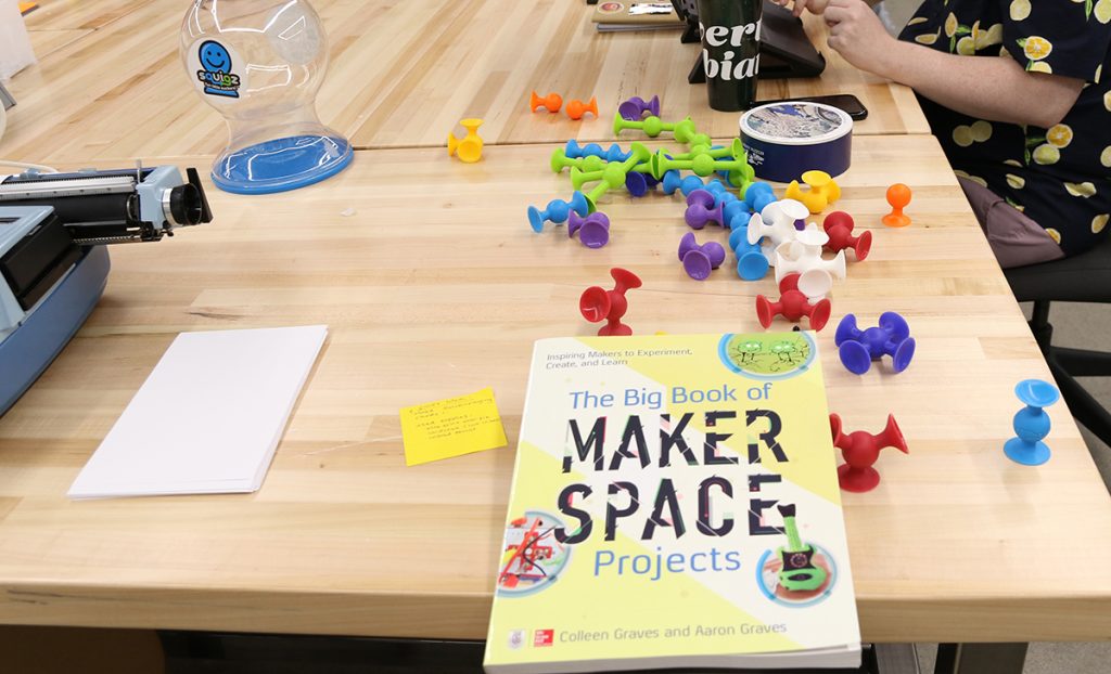 A table in the makerspace with project supplies and The Big Book of Maker Space Projects