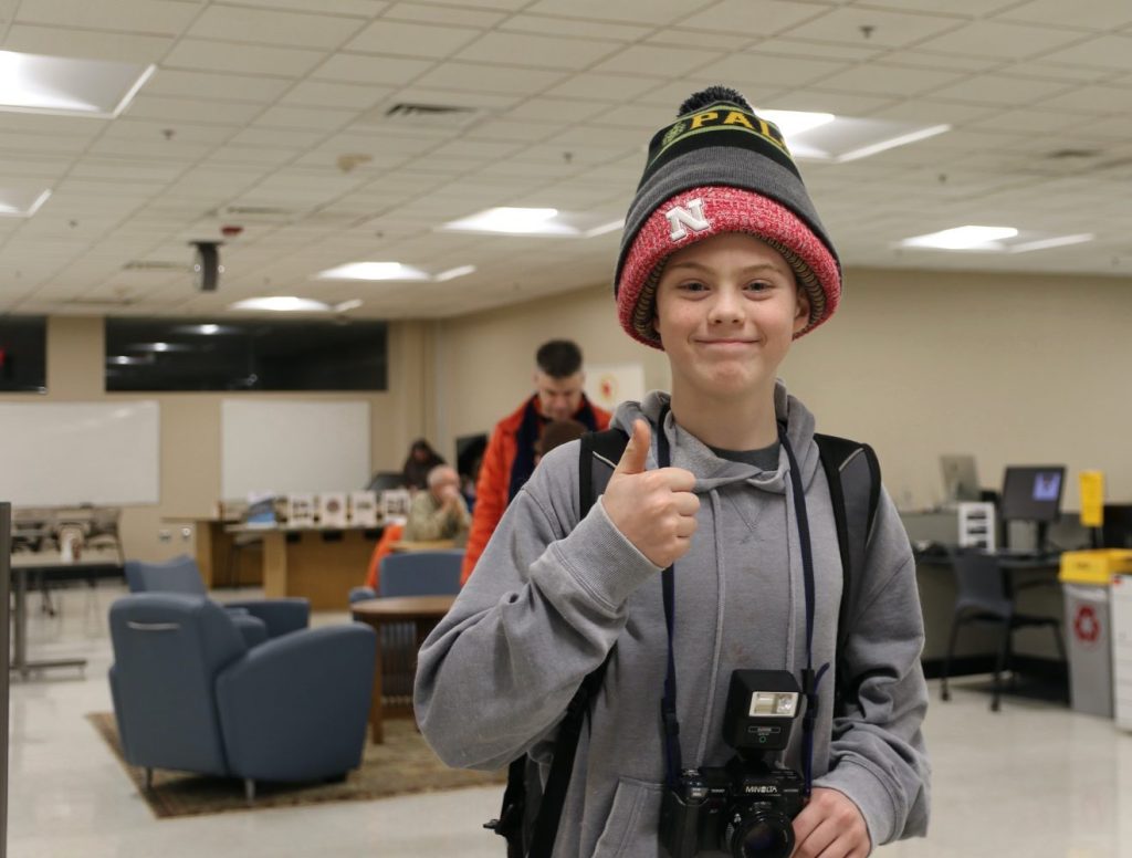 Middle school child wearing several stocking caps at one time.