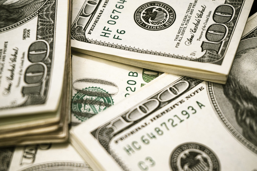 photograph of stacks of 100 dollar bills