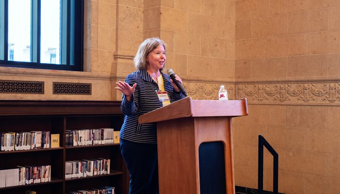 Dean Lisa German in front of a podium speaking at Founders Day