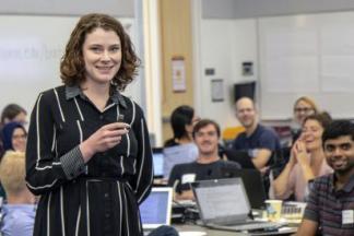 Caitlin Bakker teaching in front of a classroom