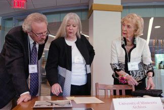 Maxine Wallin, right, browses through historical materials at the opening of the Maxine Houghton Wallin Special Collections Research Center on May 13, 2018. With her are her son Lance and Kris Kiesling, Director of the Libraries Archives and Special Collections. 