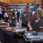 Guests gather, talk, and eat foot at the Symbolic Significance exhibit opening event on Monday, Sept. 11, 2023. (Photo/Adria Carpenter)