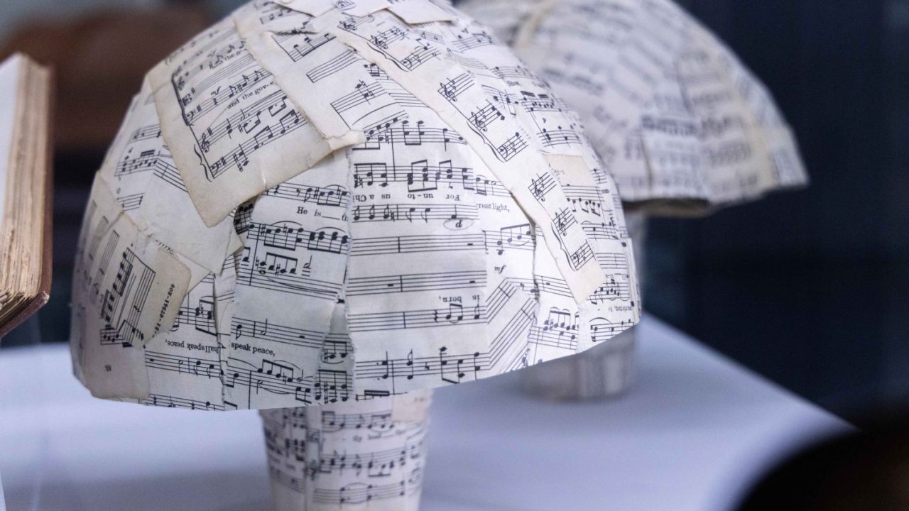 230921_awc_WHL exhibit_021 copy A model mushroom made of sheet music in the Mycophobia/Mycophilia.