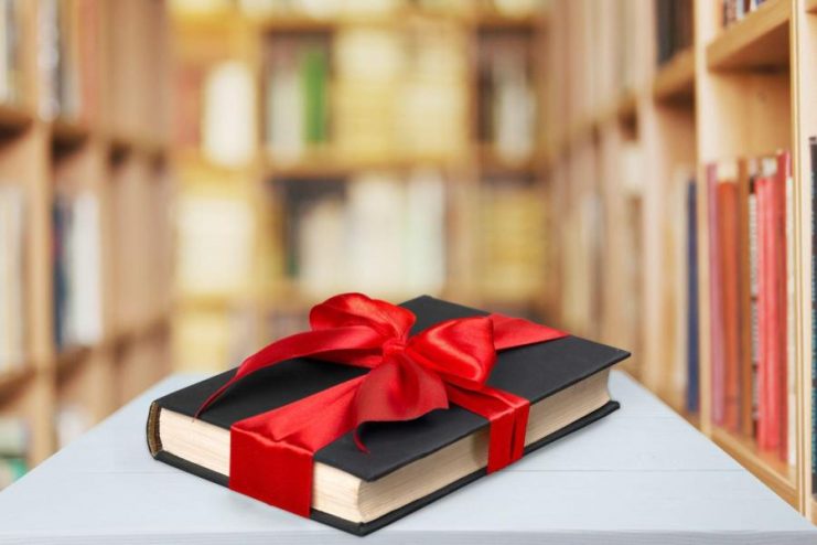 Book with a bow wrapped around it.