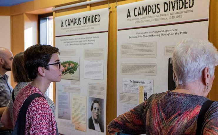 People viewing the Campus Divided exhibit