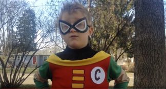 Video still of child posing as Captain Celery, standing outdoors