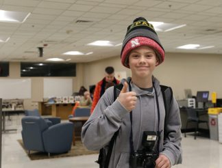 Middle school child wearing several stocking caps at one time.
