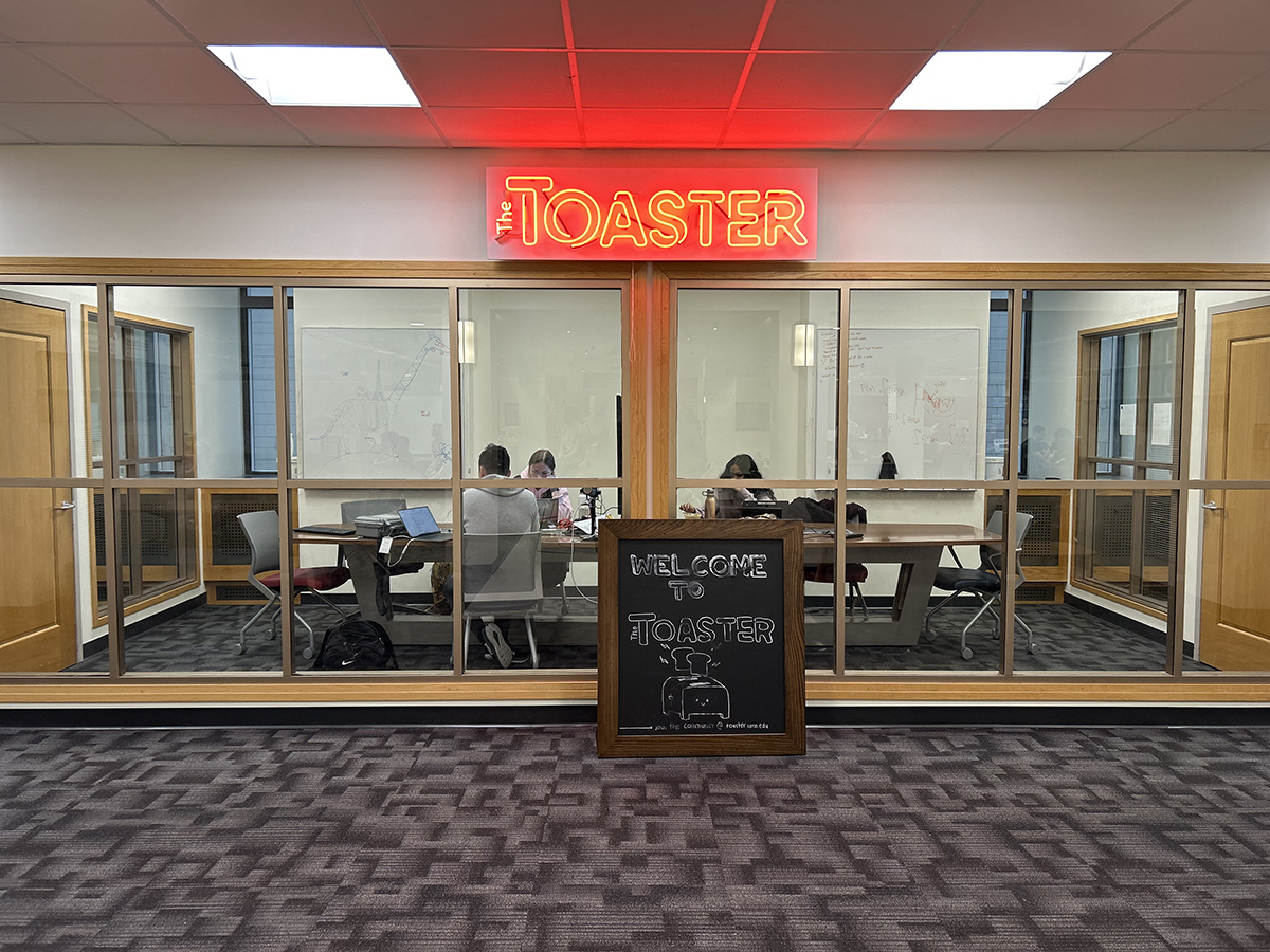 Interior of the Toaster Innovation Hub, featuring a neon sign on the wall