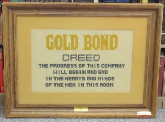 Crewel worked Gold Bond Stamp Company Creed produced by wife of early Gold Bond Stamp Company executive – “The Progress of this Company will begin and end in the hearts and minds of the men in this room.”
