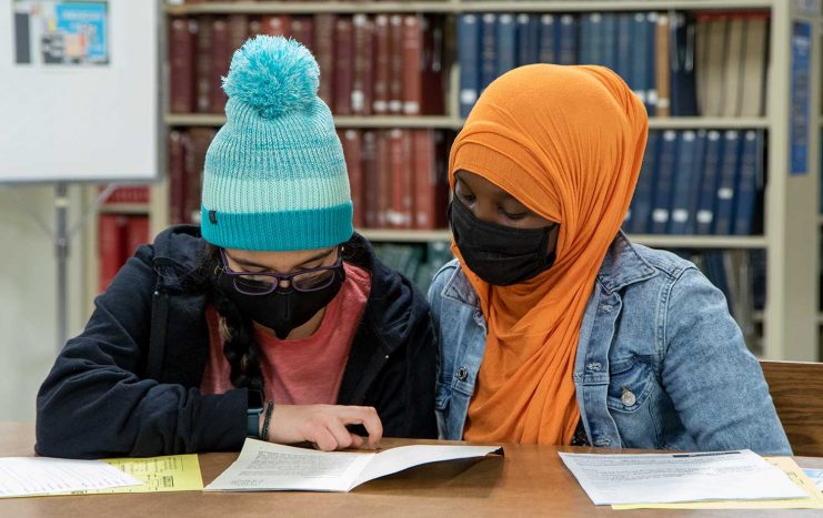 Two History Day students at Wilson Library.