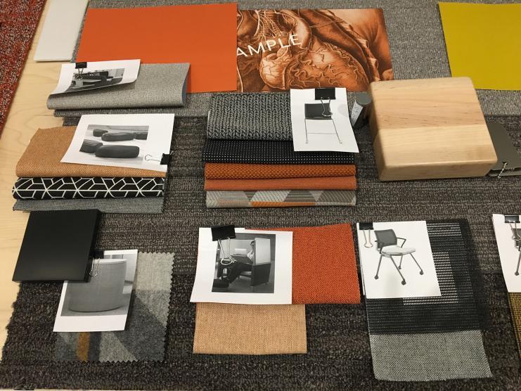 Photo of orange-themed fabric swatches and furniture finishes.