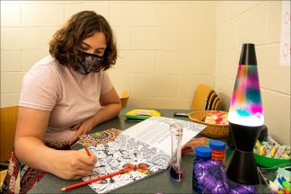 Student employee Grace tries out some of the stressbusters in the Sensory Room.