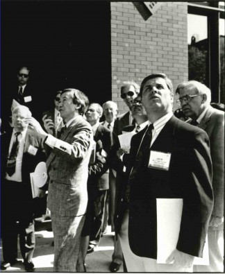 Photo- Weiming Lu stands at the center of a group of people, acting as host to an international delegation inspecting the dramatic transformations in Lowertown, St. Paul Weiming Lu papers, N279, Northwest Architectural Archives