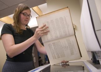 Beth Chekola scanning an article for interlibrary loan that goes out via email to a participating library in Elmer Andersen Library, Minneapolis, Minnesota.
