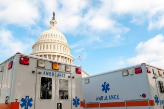 U.S. Capitol with ambulances in the foreground.