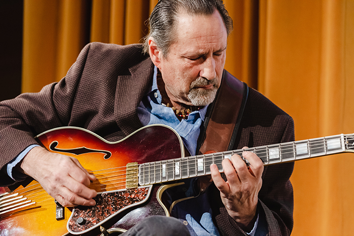 Briand Morrison plays guitar