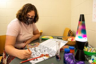 Student employee Grace tries out some of the stressbusters in the Sensory Room