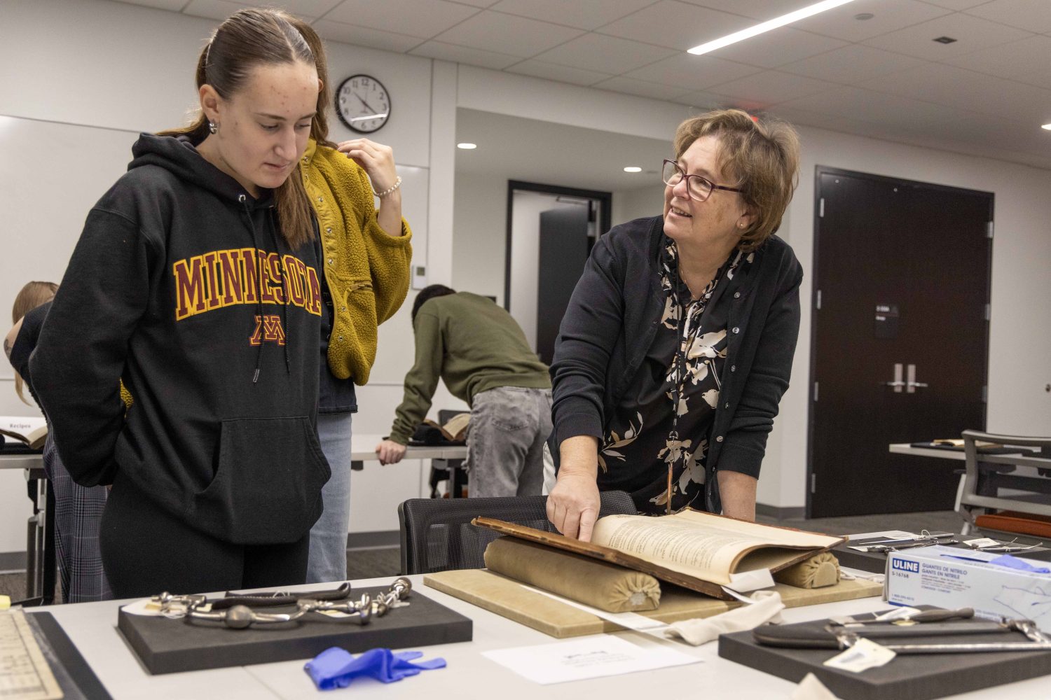 WHL Curator Lois Hendrickson talks with a student at the Wangensteen pop-up exhibit.