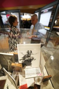 Attendees browse the display cases at the opening of PAA's "Dance Roots" exhibit, on Oct. 27, 2023. Exhibit designed by Darren Terpstra. (Photo/Luke Logan)