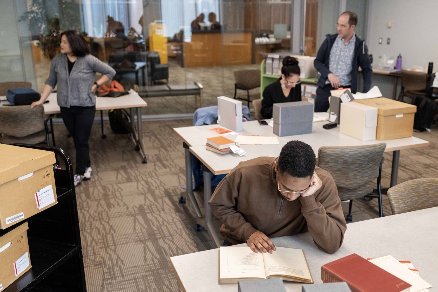 Quentin Francis, director of youth development at the Ann Arbor YMCA in Michigan, and other members of the Kautz Family YMCA Archives / YMCA of the USA Research Fellows Program pour through the archives at the University of Minnesota on Wednesday, April 17, 2024. The program aims to use the YMCA's history to inform and address current challenges related to diversity, equity, and inclusion. (Photo/Adria Carpenter)