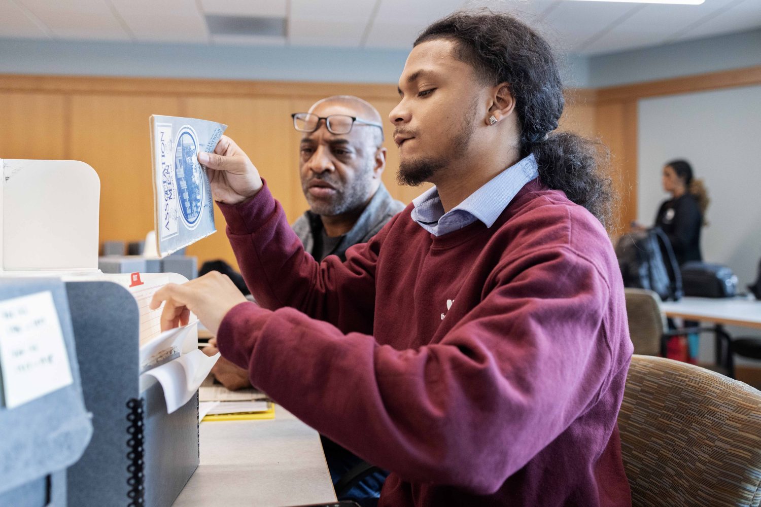 Elijah Megginson, a junior English major at Morehouse College, and Michael Levesque, executive director of Morehouse College’s National Alumni Association, scan through folders from the Kautz Family YMCA Archives, on Wednesday, April 17, 2024. (Photo/Adria Carpenter)