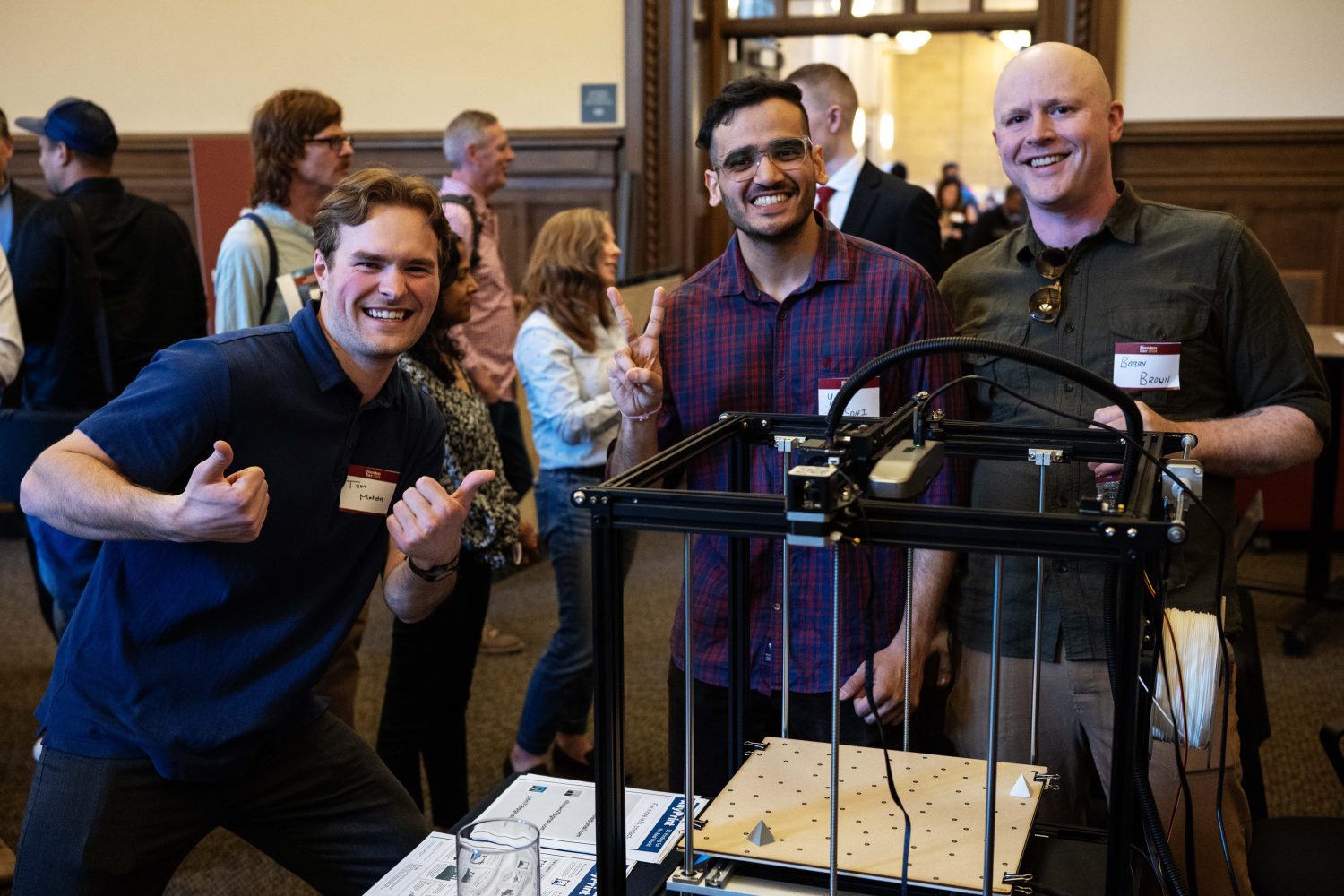 Thomas Mahota, Yash Soni, and Bobby Brown pose with their project AnyPrint, which integrates FDM 3D printing, scanning technology, and non-planar printing techniques into a new kind of conformal 3D printer, during the Minimum Viable Product Challenge for Founder's Day at Walter Library on Wednesday, May 8, 2024. (Photo/Adria Carpenter)