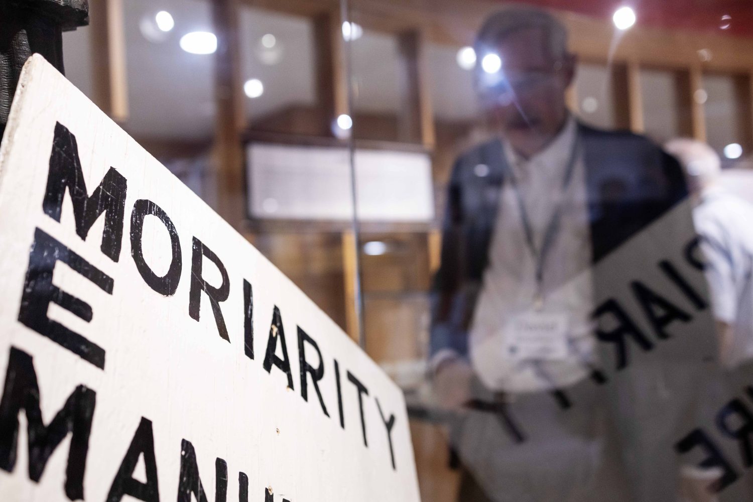 A sign celebrating the “Un-Happy Birthday” of Professor James Moriarity in the "Sherlock at 50" exhibit at Elmer L. Andersen Library on Friday, July 26, 2024. (Photo/Adria Carpenter)
