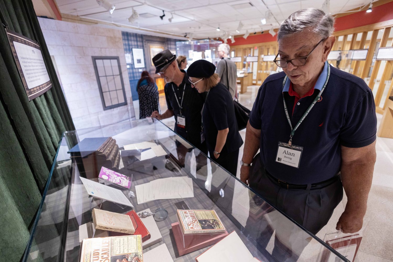 Attendees look at materials in the "Sherlock Holmes at 50" exhibit at Elmer L. Andersen Library on Friday, July 26, 2024. (Photo/Adria Carpenter)