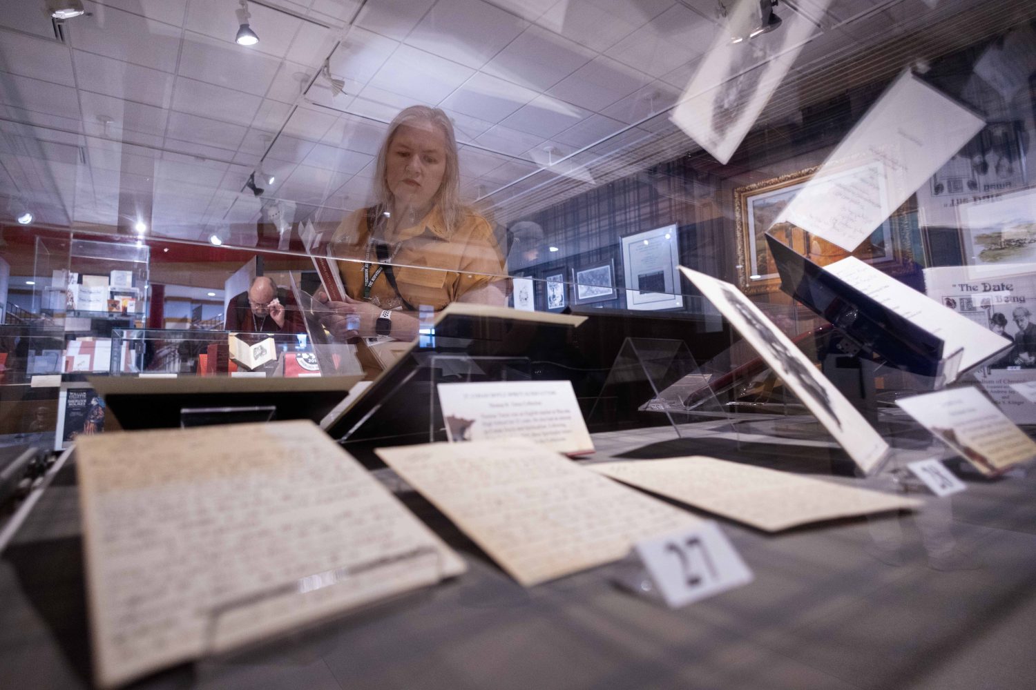 An attendee looks at materials in the "Sherlock Holmes at 50" exhibit at Elmer L. Andersen Library on Friday, July 26, 2024. (Photo/Adria Carpenter)