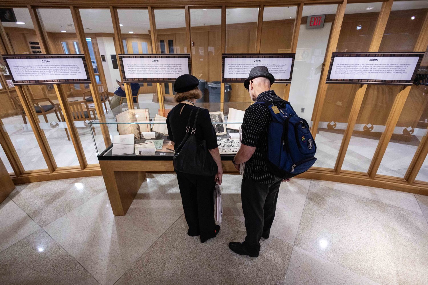 Attendees look at materials in the "Sherlock Holmes at 50" exhibit at Elmer L. Andersen Library on Friday, July 26, 2024. (Photo/Adria Carpenter)