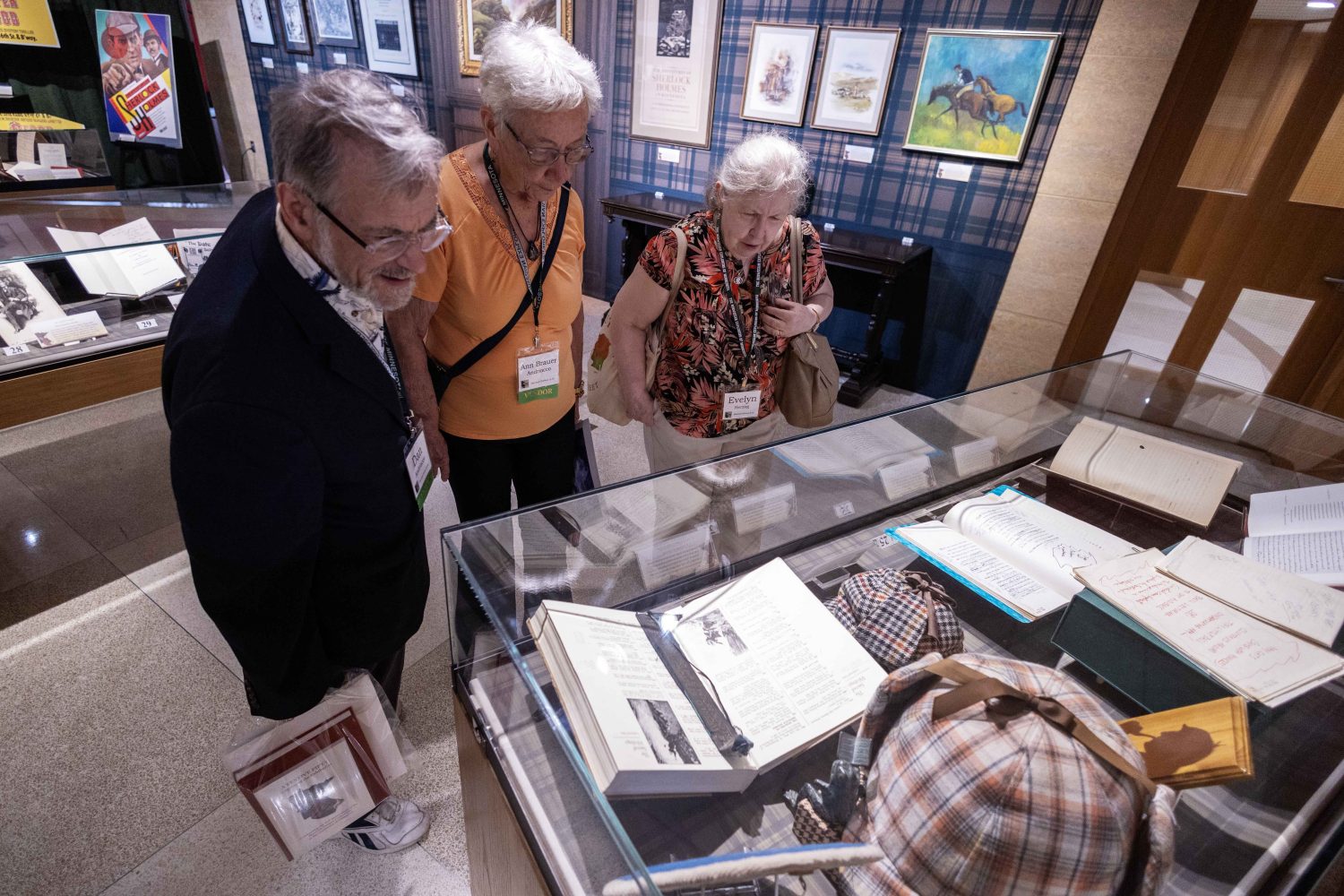 Attendees look at materials in the "Sherlock Holmes at 50" exhibit at Elmer L. Andersen Library on Friday, July 26, 2024. (Photo/Adria Carpenter)