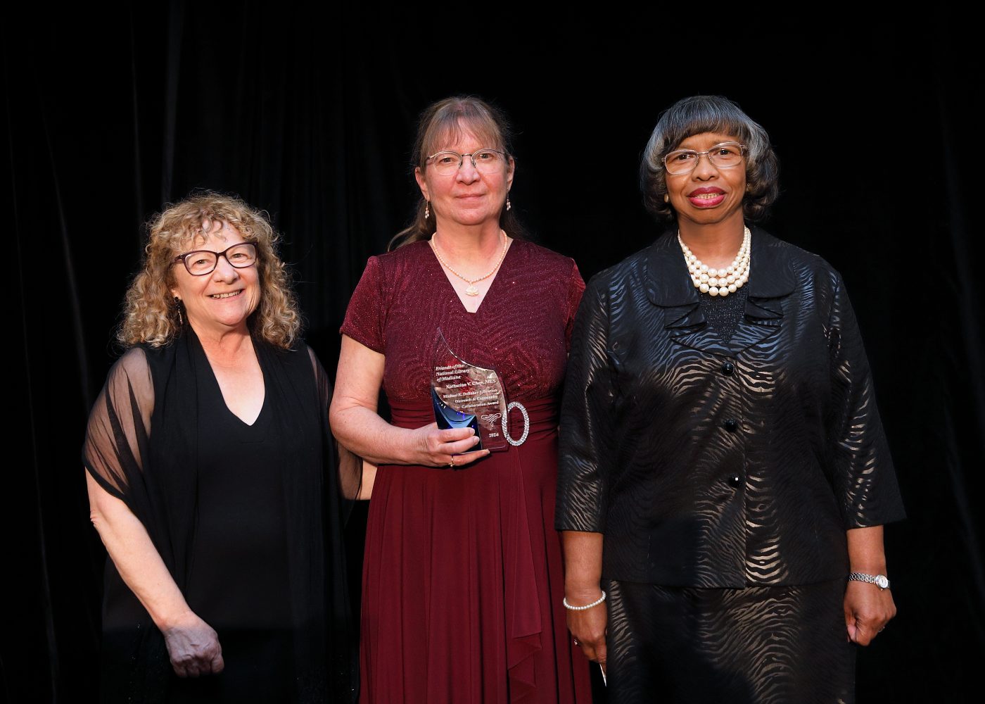Katherine Chew accepts the 2024 Michael E. DeBakey Librarian Outreach and Community Award. The Friends of the National Library of Medicine recognized Chew for her years of service an outreach librarian, representing Minnesota in Region Six. Image courtesy of the Friends of the National Library of Medicine.