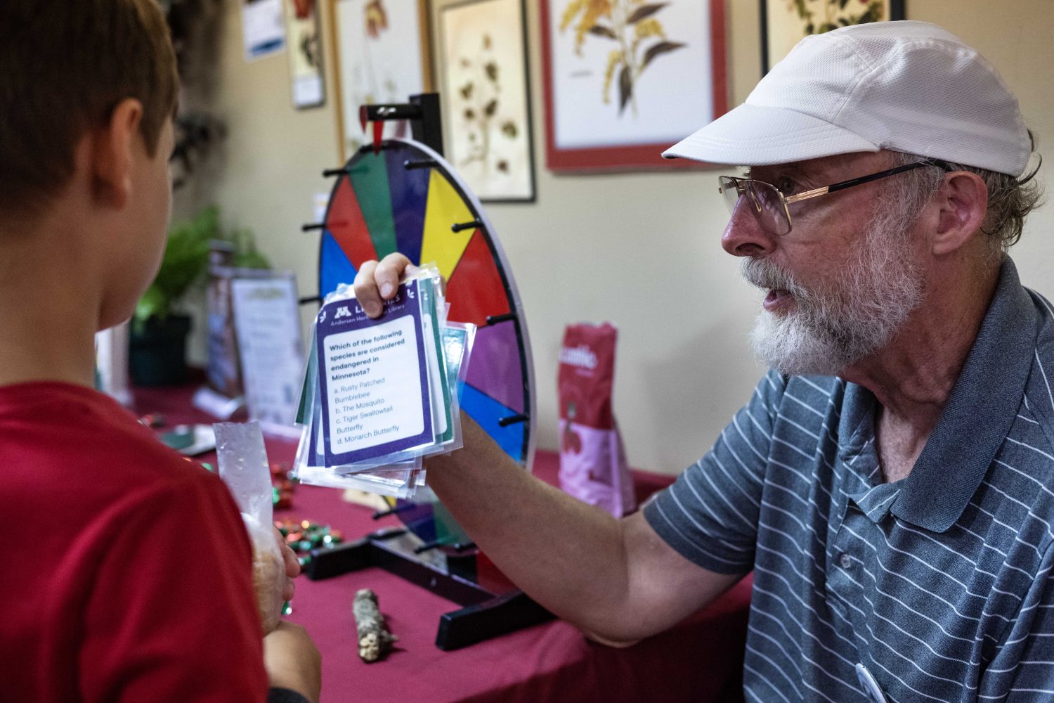 A volunteer at the Andersen Horticultural Library booth asks trivia questions at the Minnesota State Fair on Thursday, August 29, 2024. (Photo/Adria Carpenter)