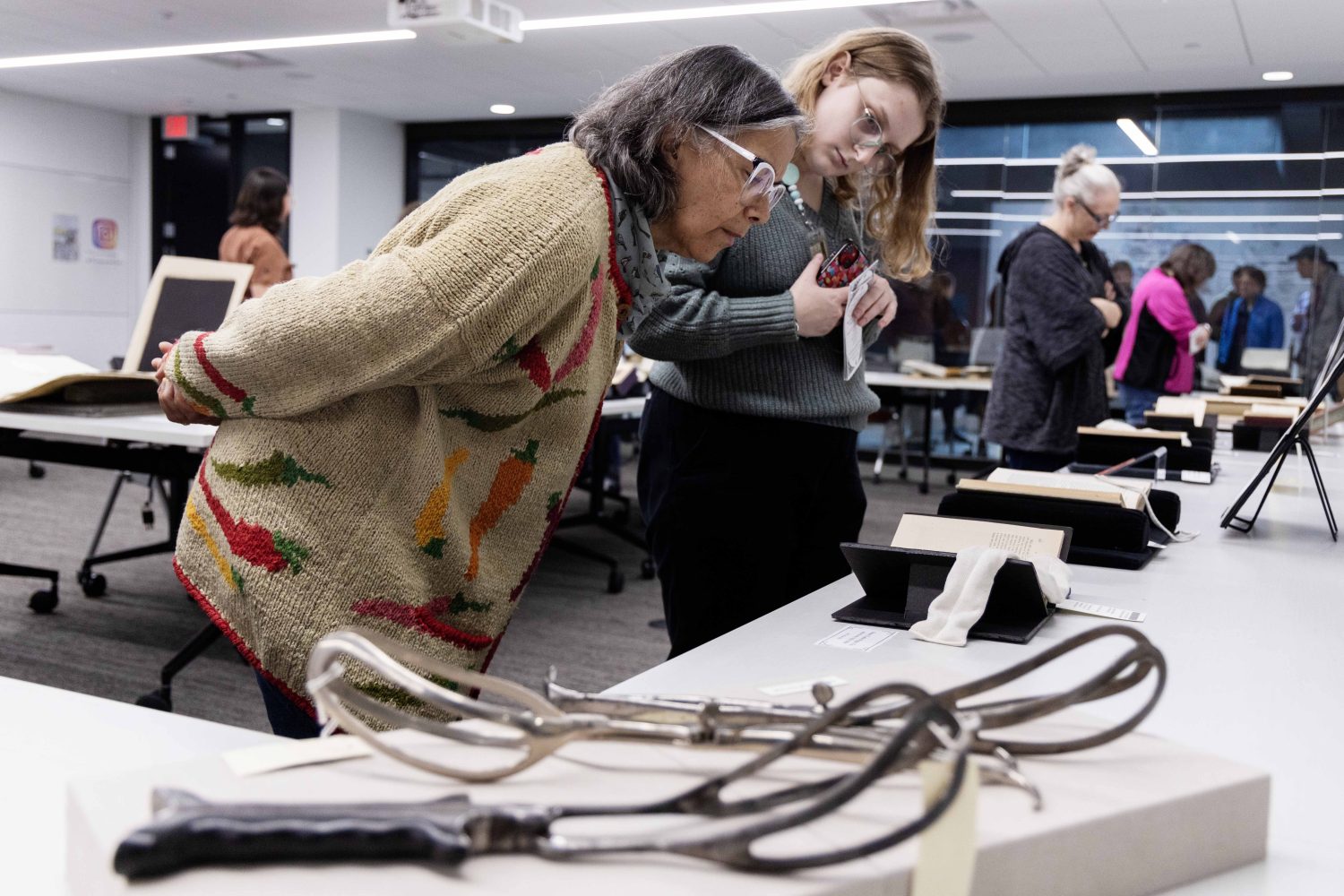 Patricia Izek, director of Diversity, Equity, Inclusion and Accessibility at University of Minnesota Libraries, examines materials from the Wangensteen Historical Library's exhibit "Disembodied Reembodied," on Thursday, October 24, 2024. (Photo/Adria Carpenter)
