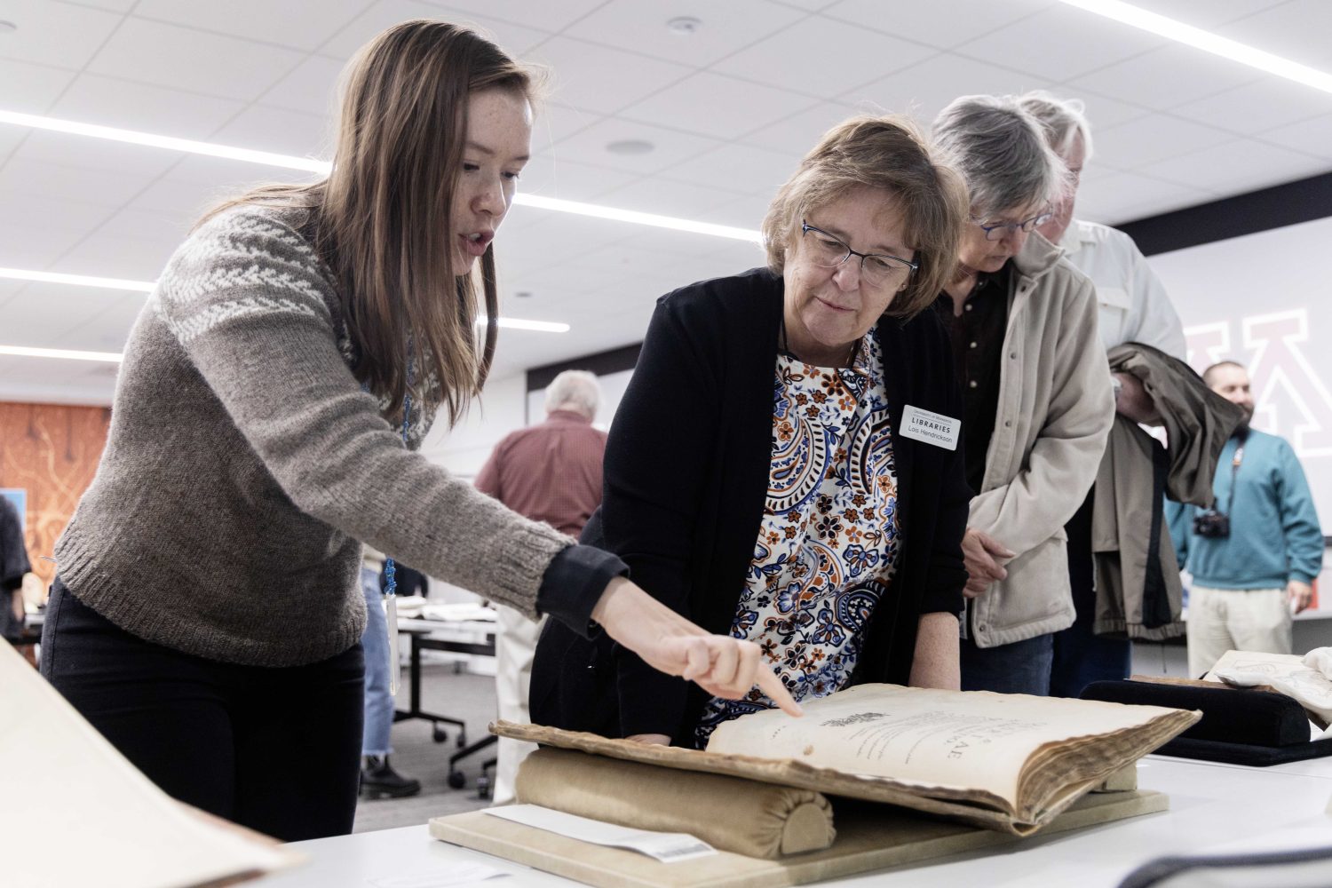 Lois Hendrickson, curator of the Wangensteen Historical Library, speaks with guests at "Disembodied Reembodied" exhibit, on Thursday, October 24, 2024. (Photo/Adria Carpenter)