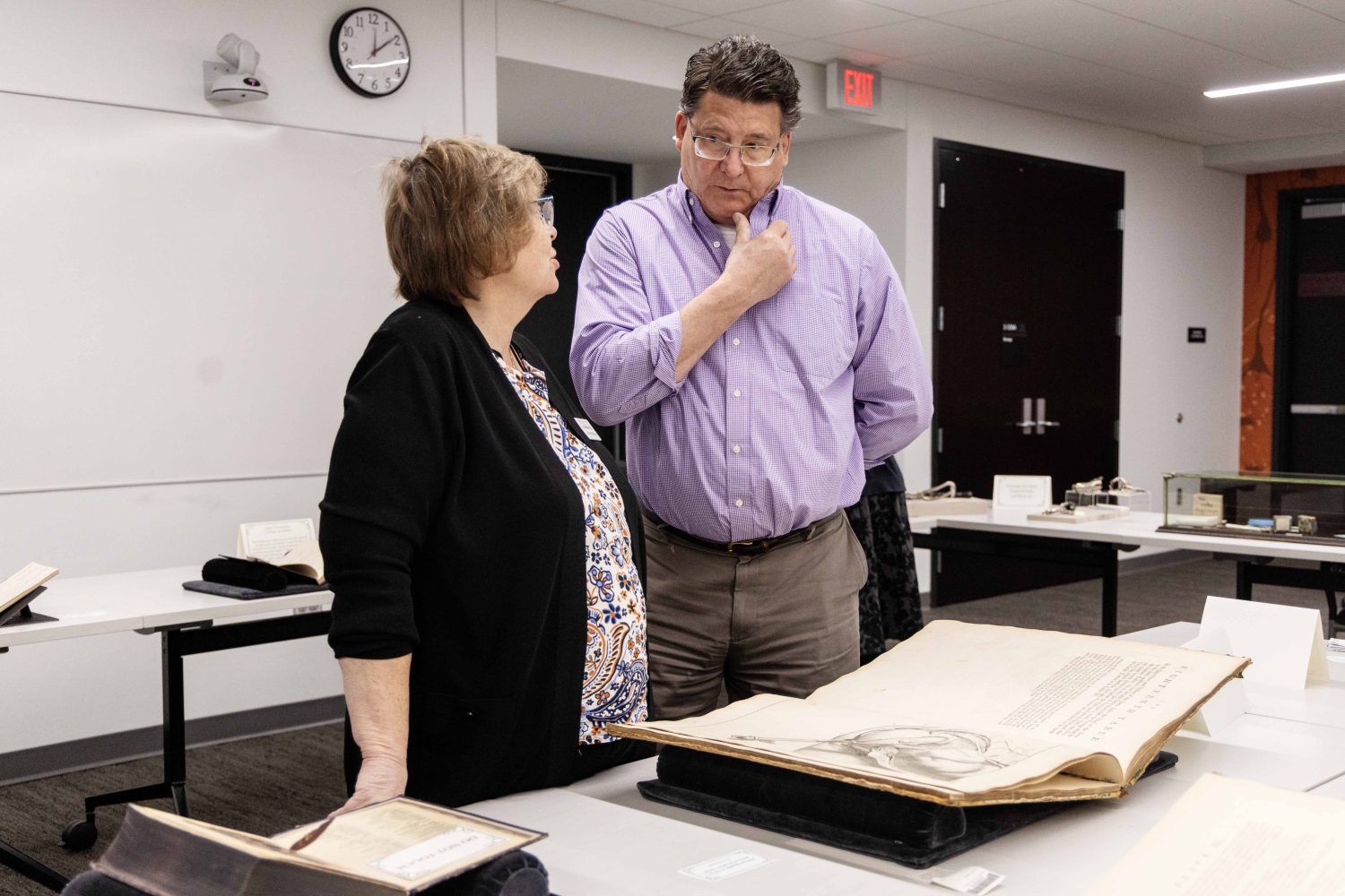 Lois Hendrickson, curator of the Wangensteen Historical Library, speaks with guests at "Disembodied Reembodied" exhibit, on Thursday, October 24, 2024. (Photo/Adria Carpenter)