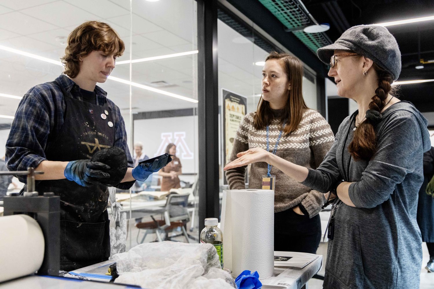 Sydney Petersen, a printing assistant, demonstrates how prints are made at the Wangensteen Historical Library's exhibit "Disembodied Reembodied," on Thursday, October 24, 2024. (Photo/Adria Carpenter)