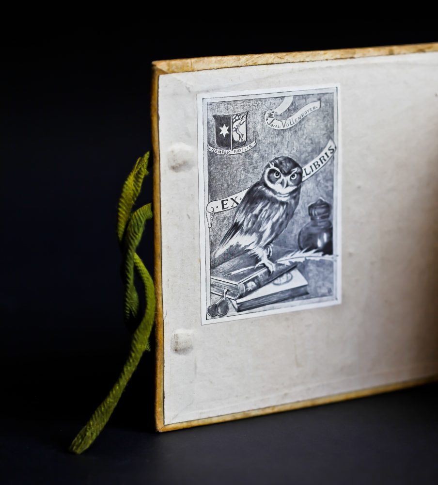 The inside of a book cover, with bookplate depicting an owl standing on books, with the label: "Ex Libris"
