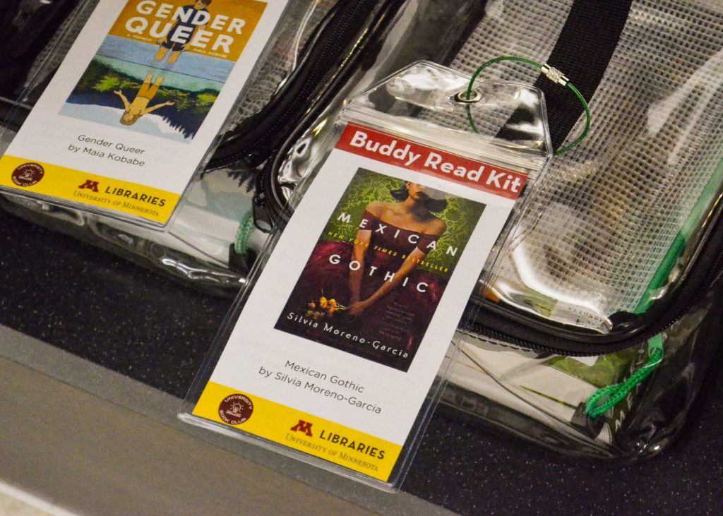 Two clear bags containing buddy read kits for Gender Queer and Mexican Gothic.