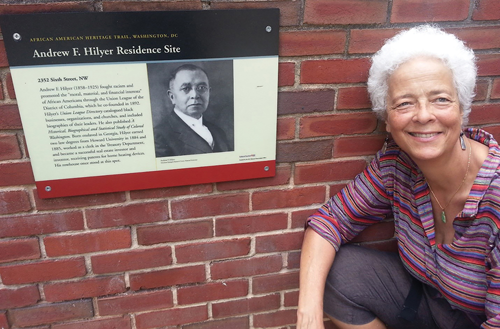 S. Barbara Hilyer poses beside a plaque about her great grandfather Andrew F. Hilyer on the African American Heritage Trail in Washington D.C.