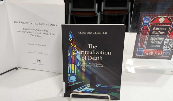 Three books on the topic of mortuary science on display.